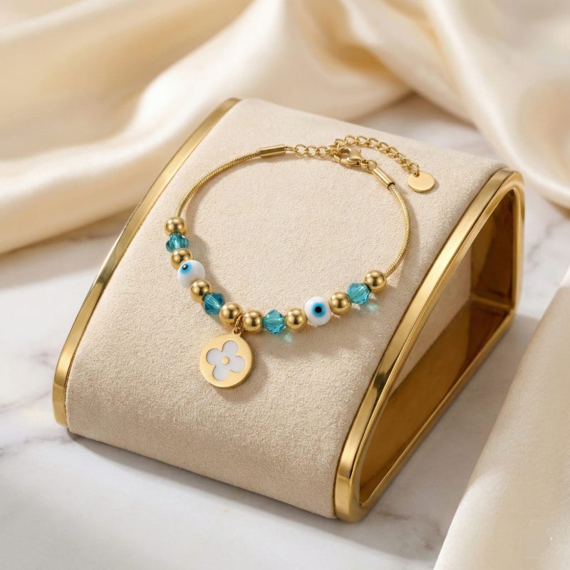 A gold bracelet made of rust-resistant stainless steel, with a thin design adorned with gold and turquoise beads and an elegant eye shape with a white rose pendant, with an adjustable clasp to fit you. - Image 5